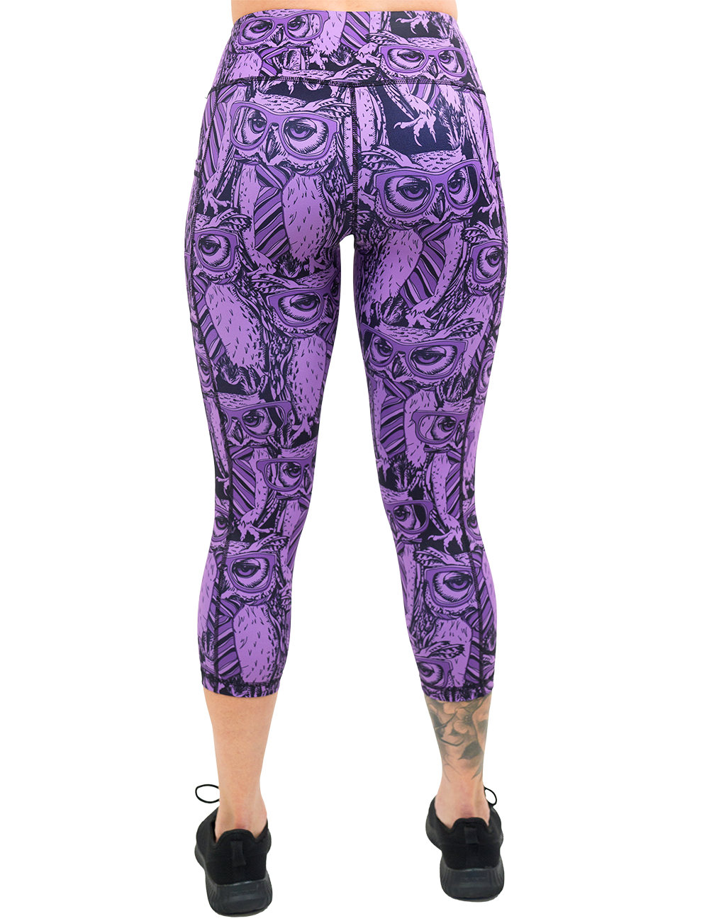 back of the purple owl wearing glasses and a tie print capri leggings against a white background