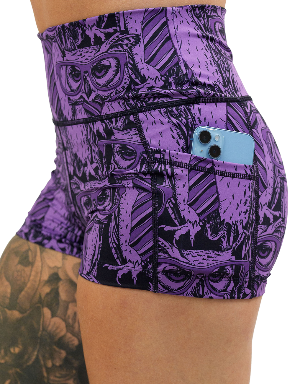 close up of the purple owl wearing glasses and a tie print 2.5 inch shorts with a phone in its pocket against a white background