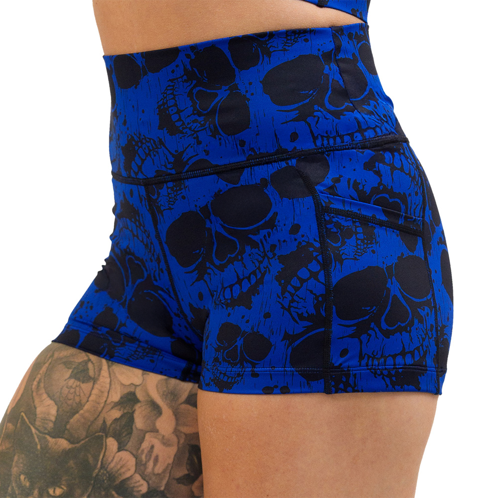 close up of the 2.5 inch dark skulls against a blue background pattern shorts against a white background