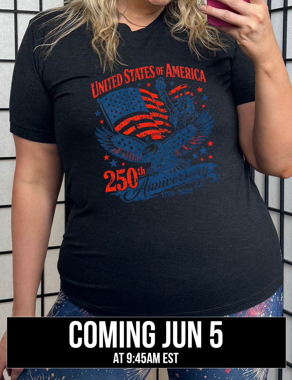 black unisex tee with the graphic of the eagle, wings spread, the statue of liberty, and an American flag, and lots of little stars, and the words saying "United Stated of America 250th Anniversary 1776-2026", coming june 5th