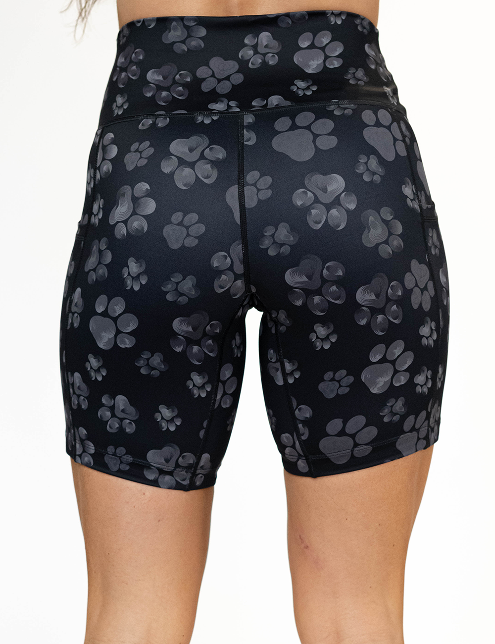back of the 7 inch grey paw prints against a black background shorts