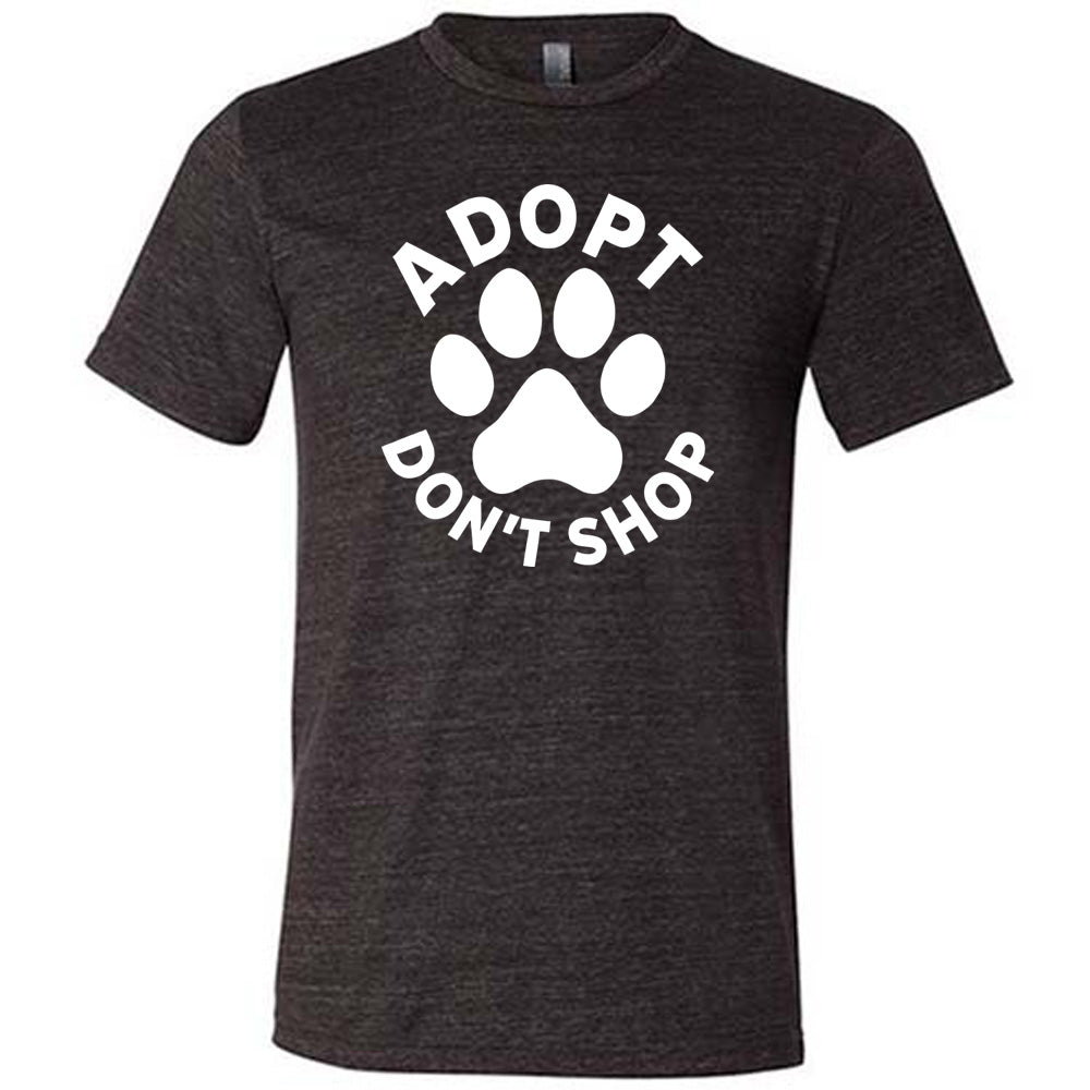 Black colored shirt with paw print graphic on it that says "Adopt Don't Shop"