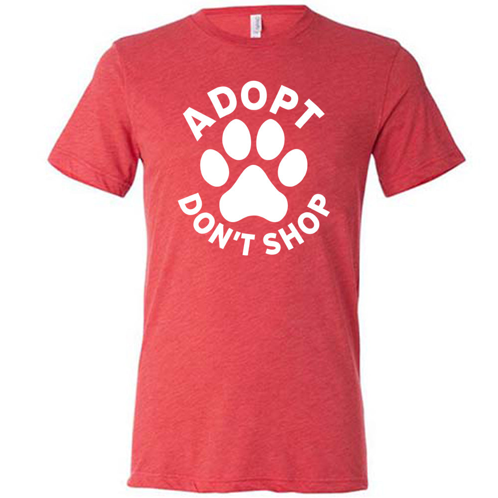 Red colored shirt with paw print graphic on it that says "Adopt Don't Shop"