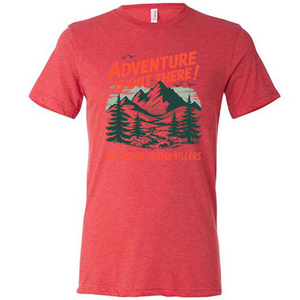 red unisex tee with the words "adventure is out there! but so are serial killers" on it, with the graphic of mountains and woods and birds flying