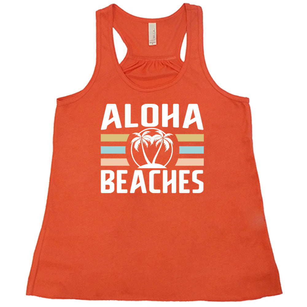 Coral colored flowy tank with a palm tree graphic on it that says "Aloha Beaches"