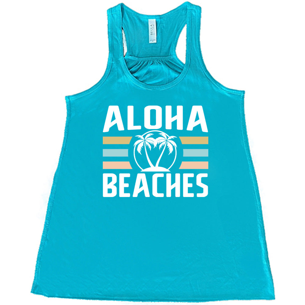 Teal colored flowy tank with a palm tree graphic on it that says "Aloha Beaches"