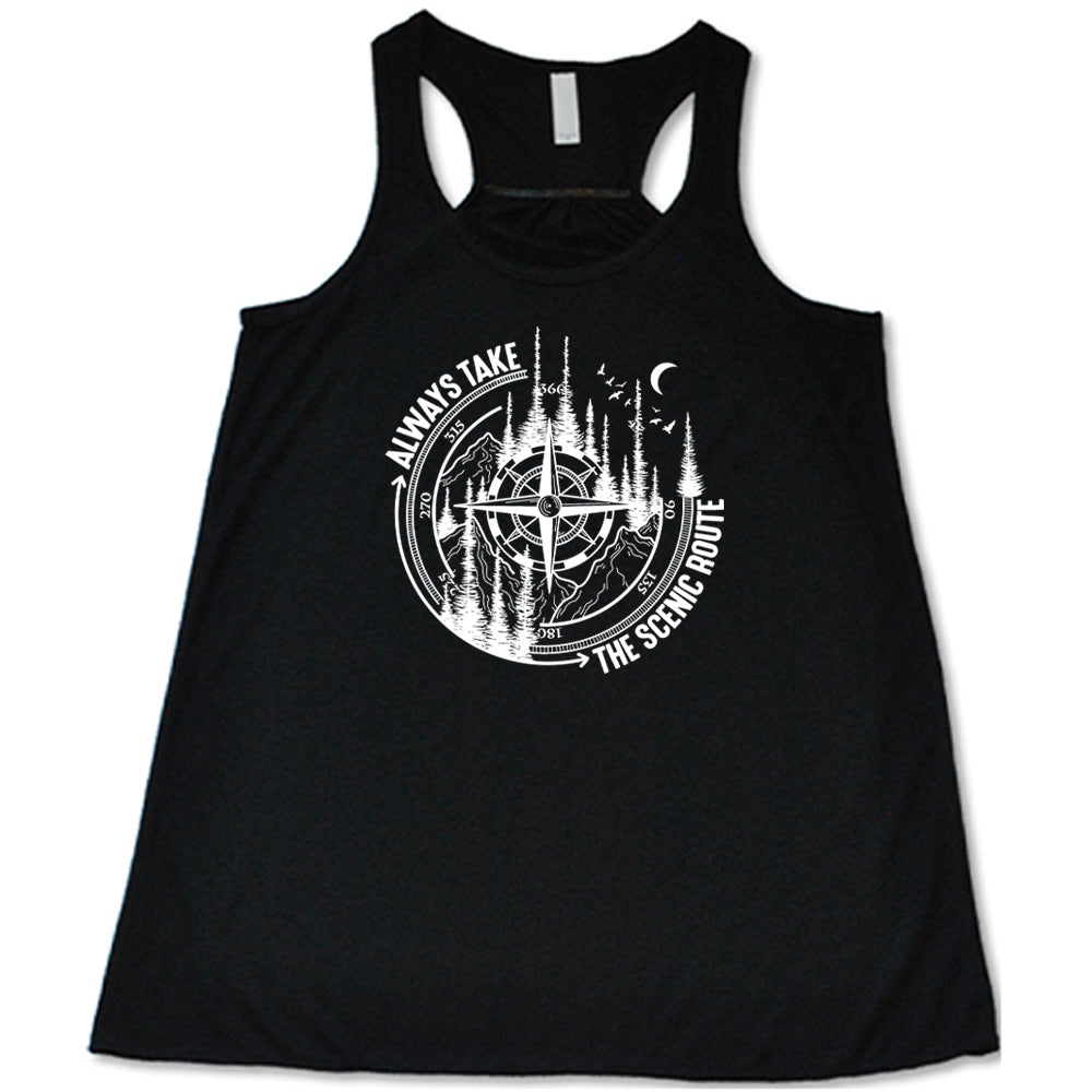 Black colored flowy tank with a compass and forest graphic on it that says "Always Take The Scenic Route"