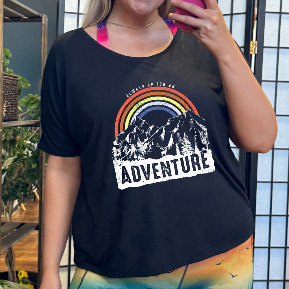 shirt with a rainbow over mountains graphic on it that says "Always Up For An Adventure"