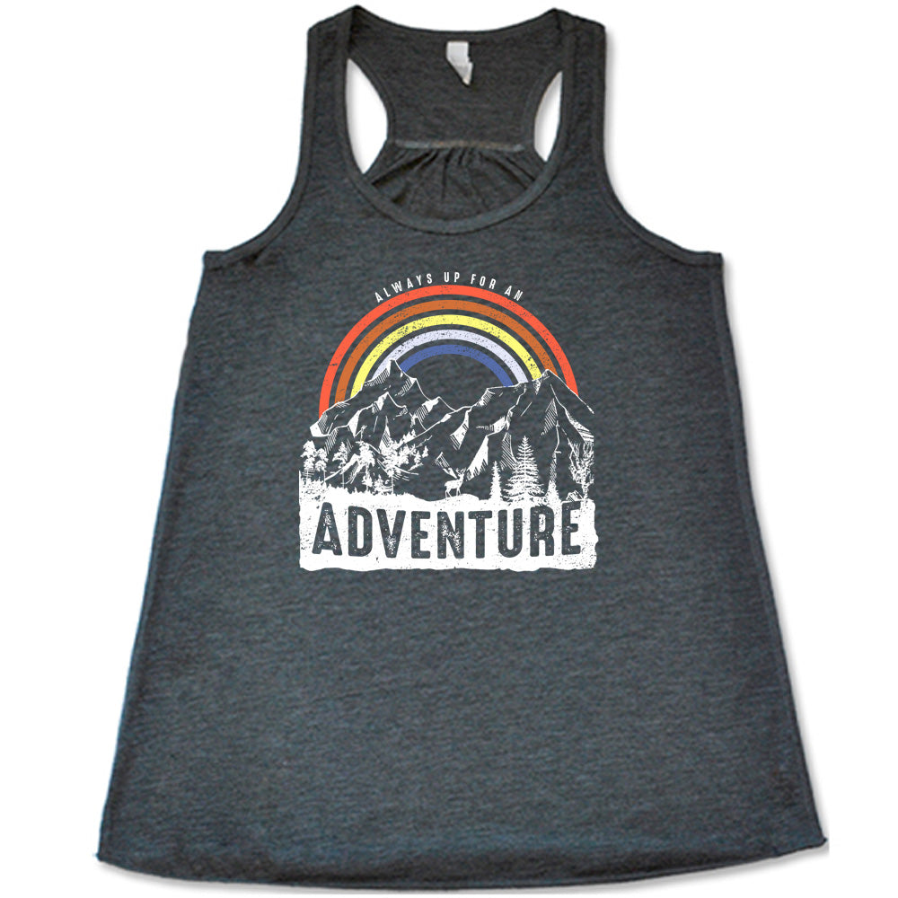 Grey colored flowy tank with a rainbow over mountains graphic on it that says "Always Up For An Adventure"