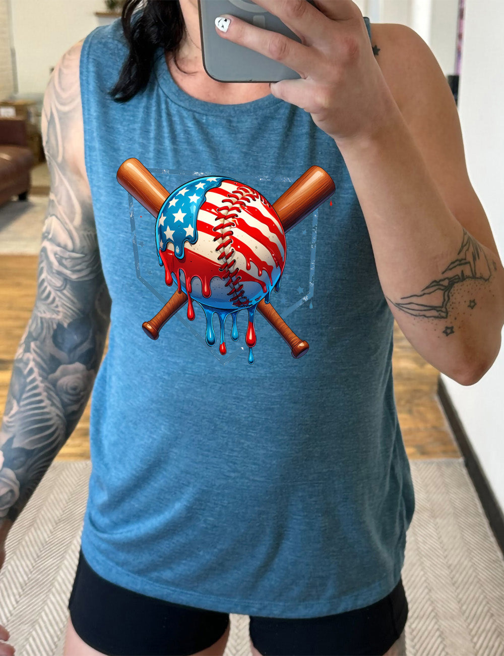 deep teal muscle tank with the graphic of a baseball painted (and dripping) with the American flag, and two baseball bats crossed behind it, all in front of a starry baseball diamond