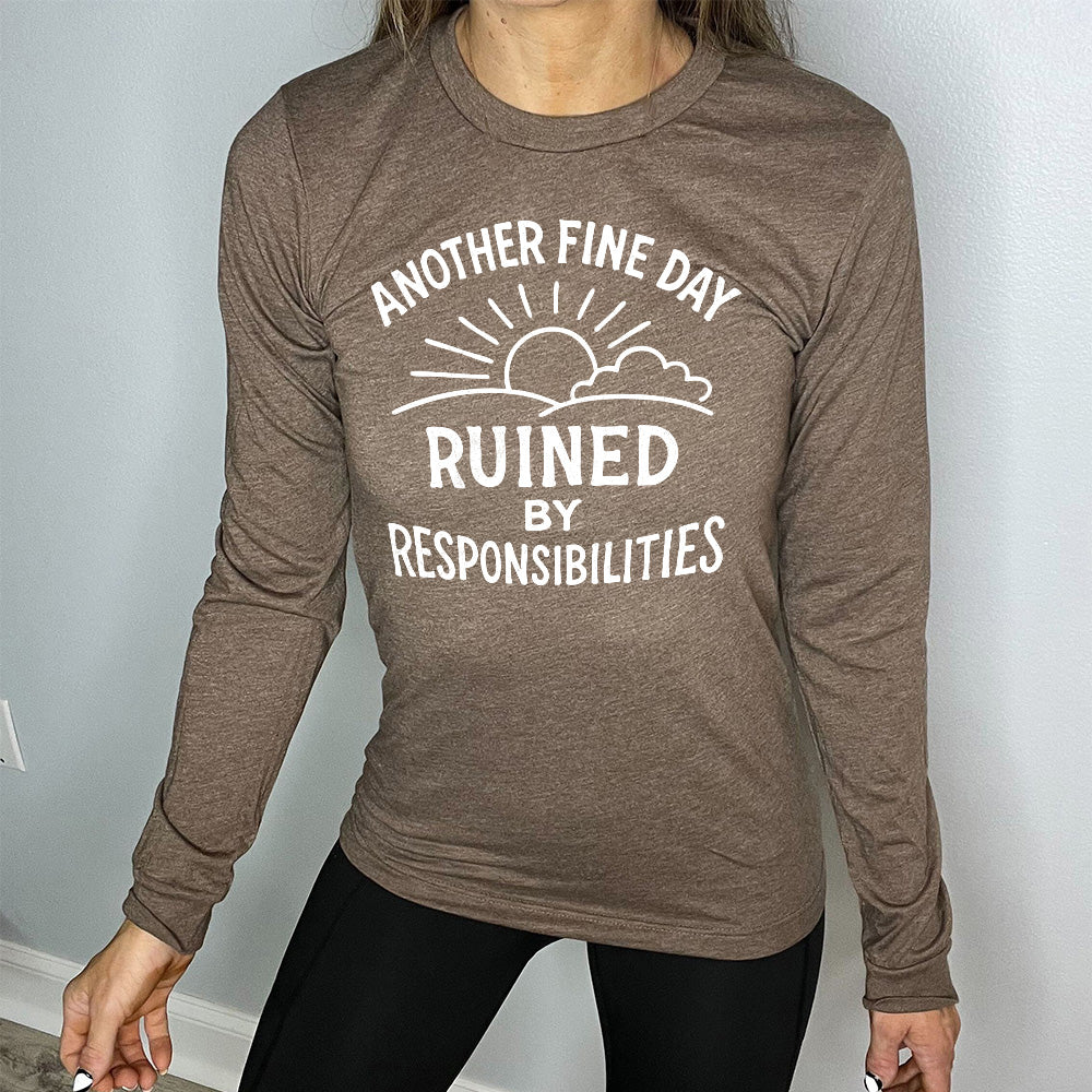 heather brown long sleeve shirt with wording "Another Fine Day Ruined By Responsibilities" in white lettering, with a sunrise graphic