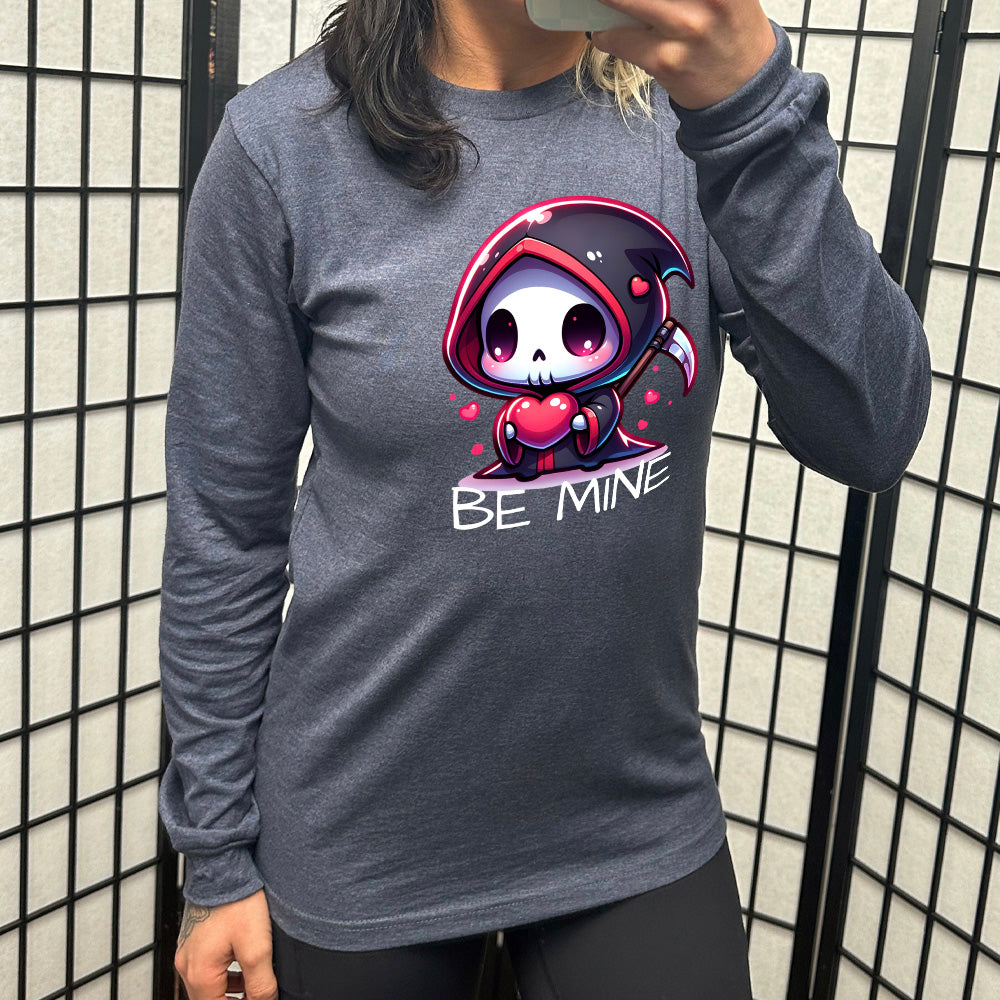 heather navy long sleeve with large graphics of a cartoony grim reaper holding a heart, with little hearts surrounding, and the words "be mine" on it