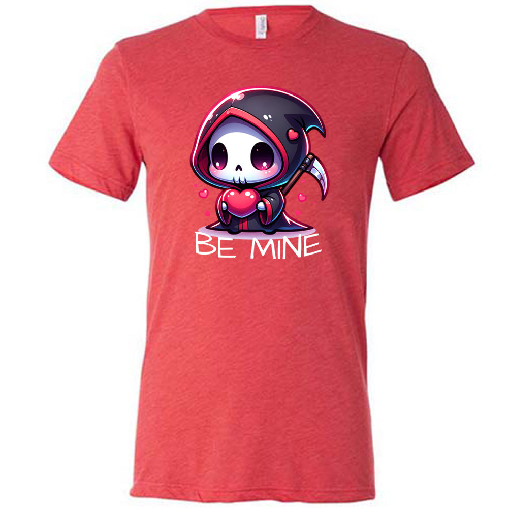 red unisex tee with large graphics of a cartoony grim reaper holding a heart, with little hearts surrounding, and the words "be mine" on it