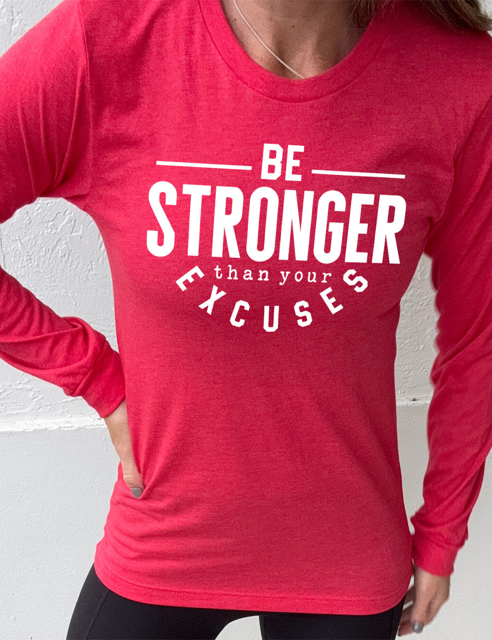 heather red long sleeve tee with words on it saying "be STRONGER than your excuses", with lines in front and after the word "be", the word "stronger" in the largest font, and the word "excuses" arching