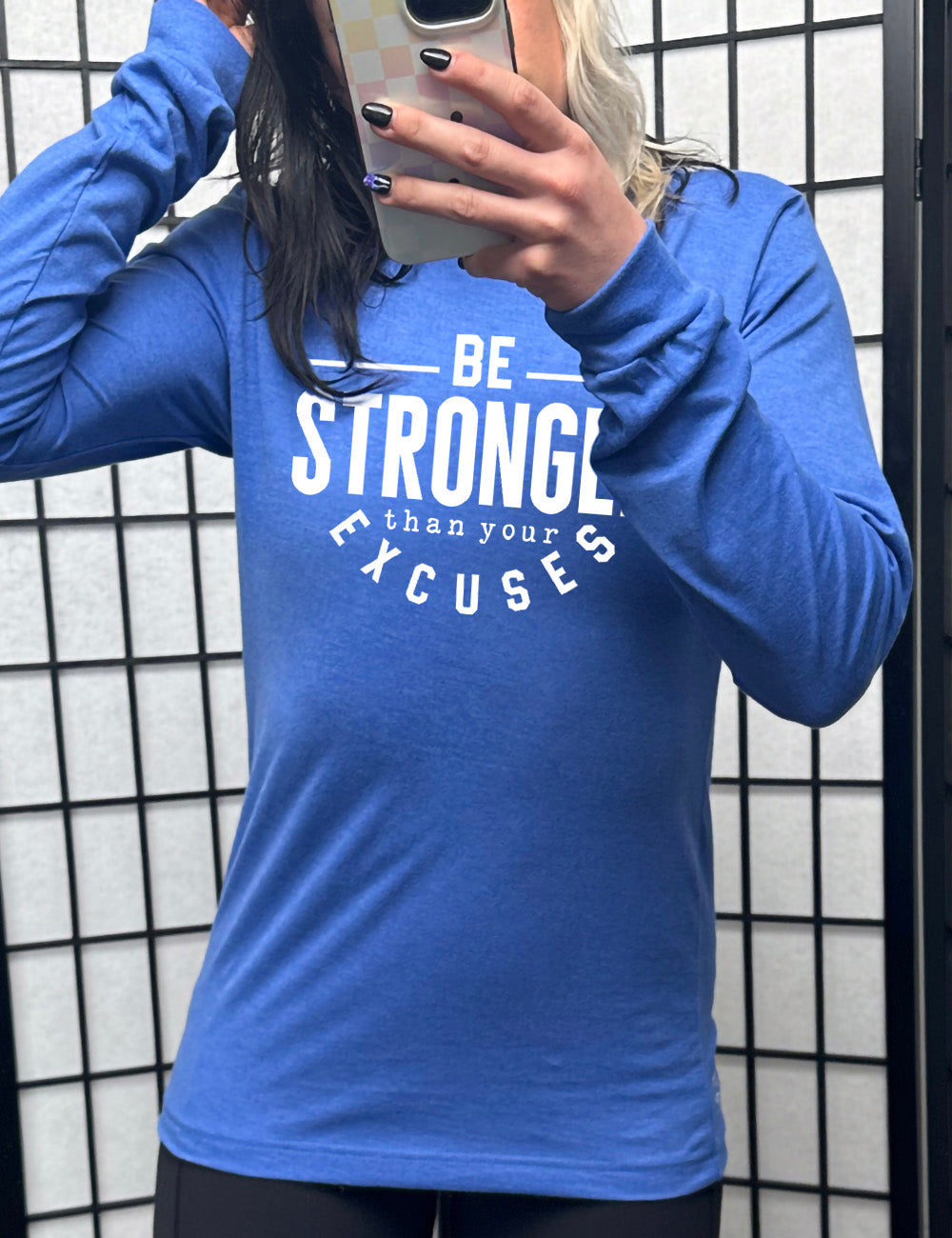 heather true royal long sleeve tee with words on it saying "be STRONGER than your excuses", with lines in front and after the word "be", the word "stronger" in the largest font, and the word "excuses" arching