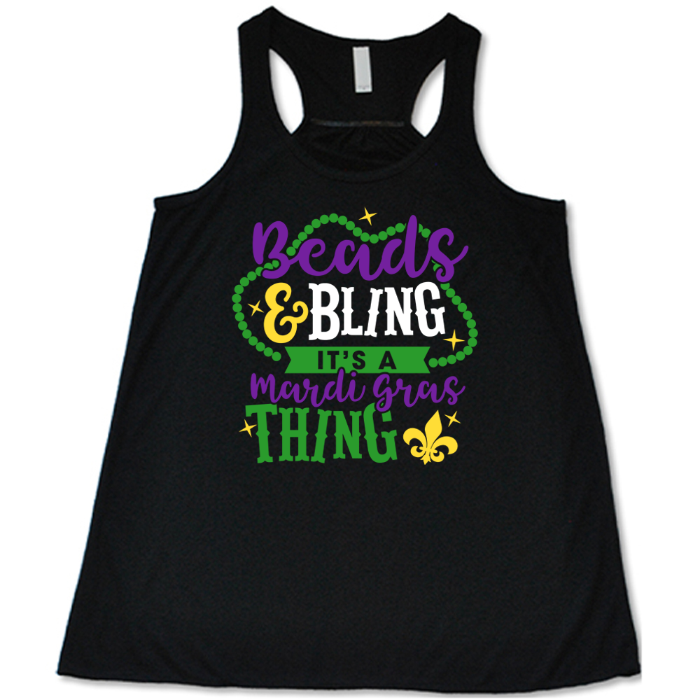 black flowy tank with the words "beads & bling it's a mardi gras thing" on it, with graphics of a ring of beads around part of the words and a few stars as well as a fleur-de-lis symbol