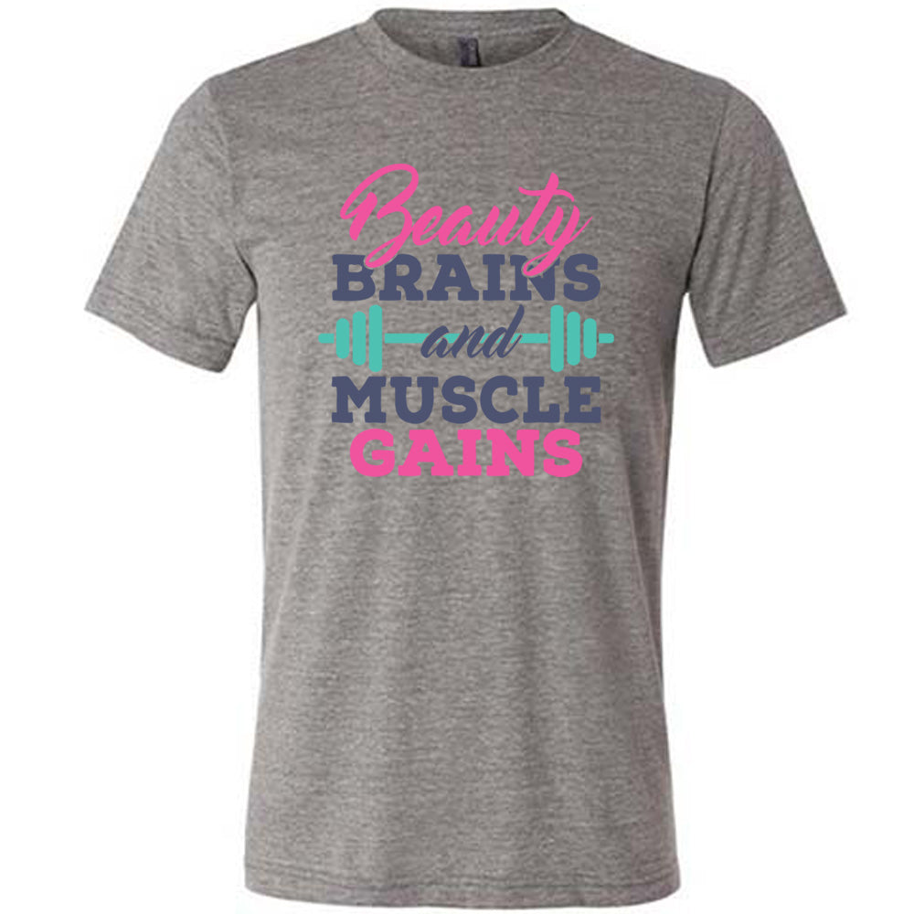 Grey Unisex Tee, with wording Beauty Brains and Muscle Gains, multicolored lettering with a barbell