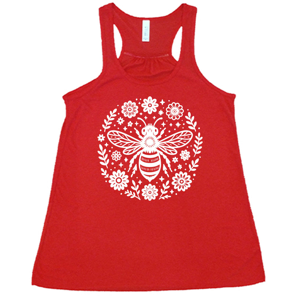 red flowy racerback tank with the graphic of a boho circled design filled with flowers of varied size, some branches, some stars, and in the center a fancy bee