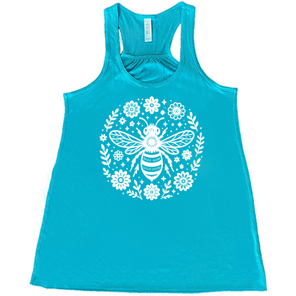 teal flowy racerback tank with the graphic of a boho circled design filled with flowers of varied size, some branches, some stars, and in the center a fancy bee