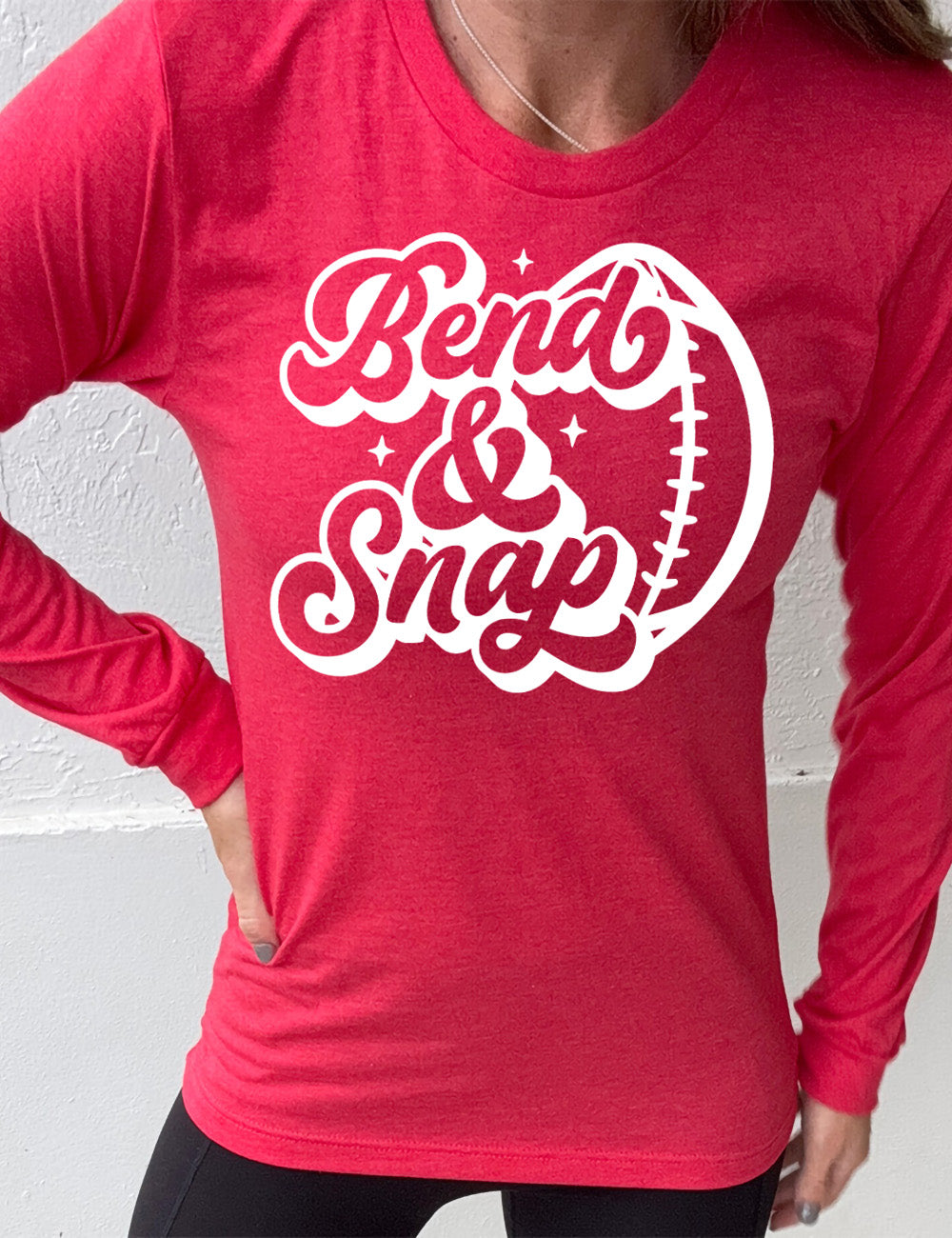 heather red long sleeve tee with the words in cursive saying "Bend & Snap" with the outline graphic of a football slightly underneath