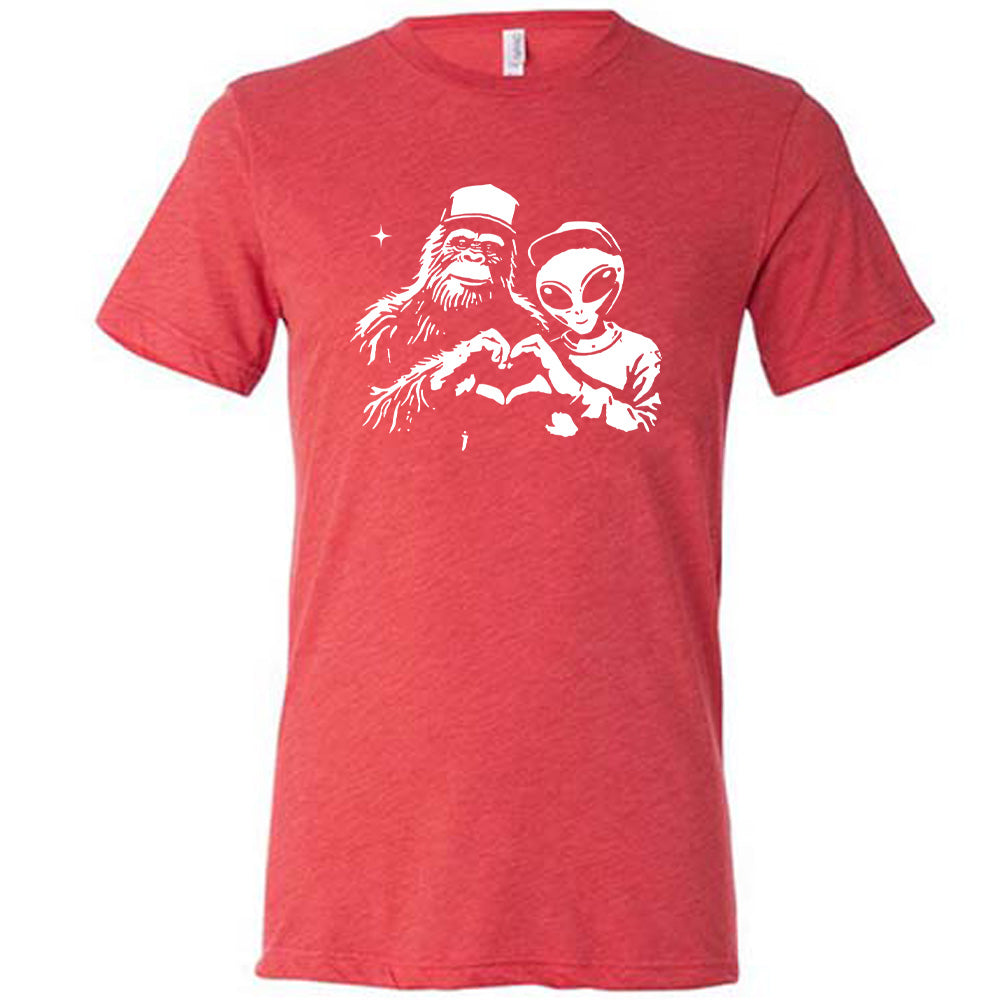 Red colored shirt with bigfoot and alien doing heart hands graphic on it
