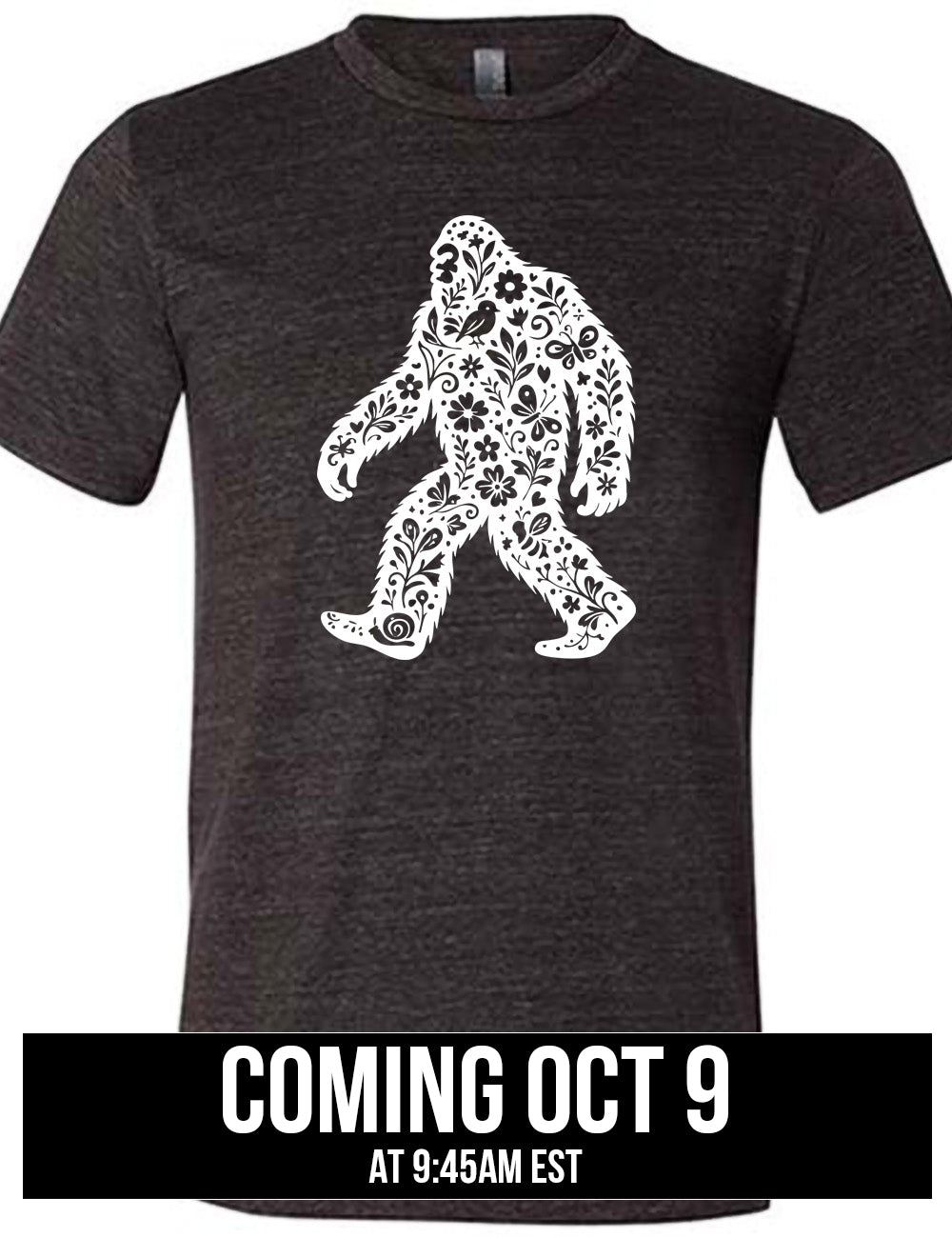 black unisex tee with the graphic white cutout of bigfoot, which is overlayed with black flowers, plants, birds, bees, snails, and butterflies, coming October 9th