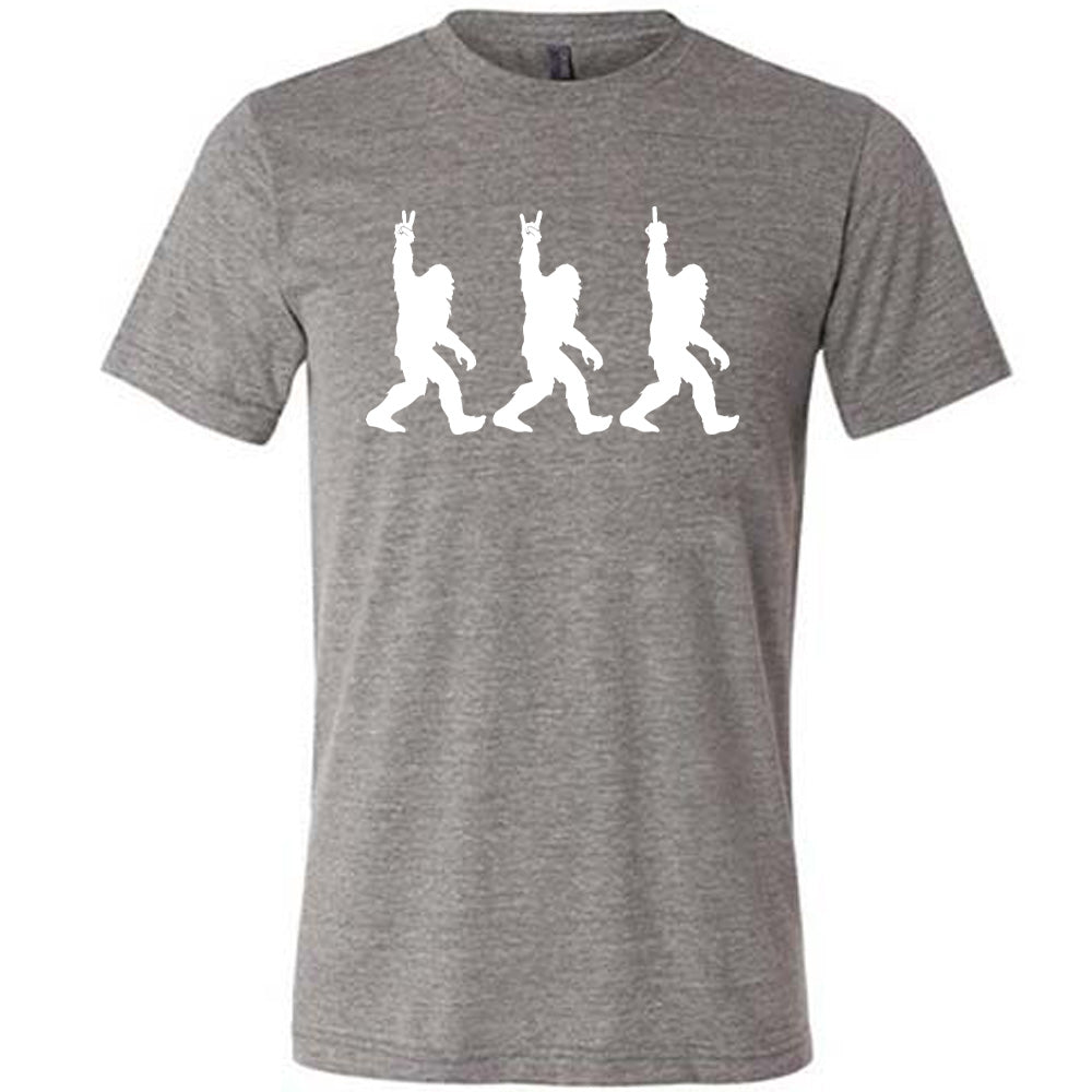 Grey colored shirt with bigfoot doing peace sign graphic on it