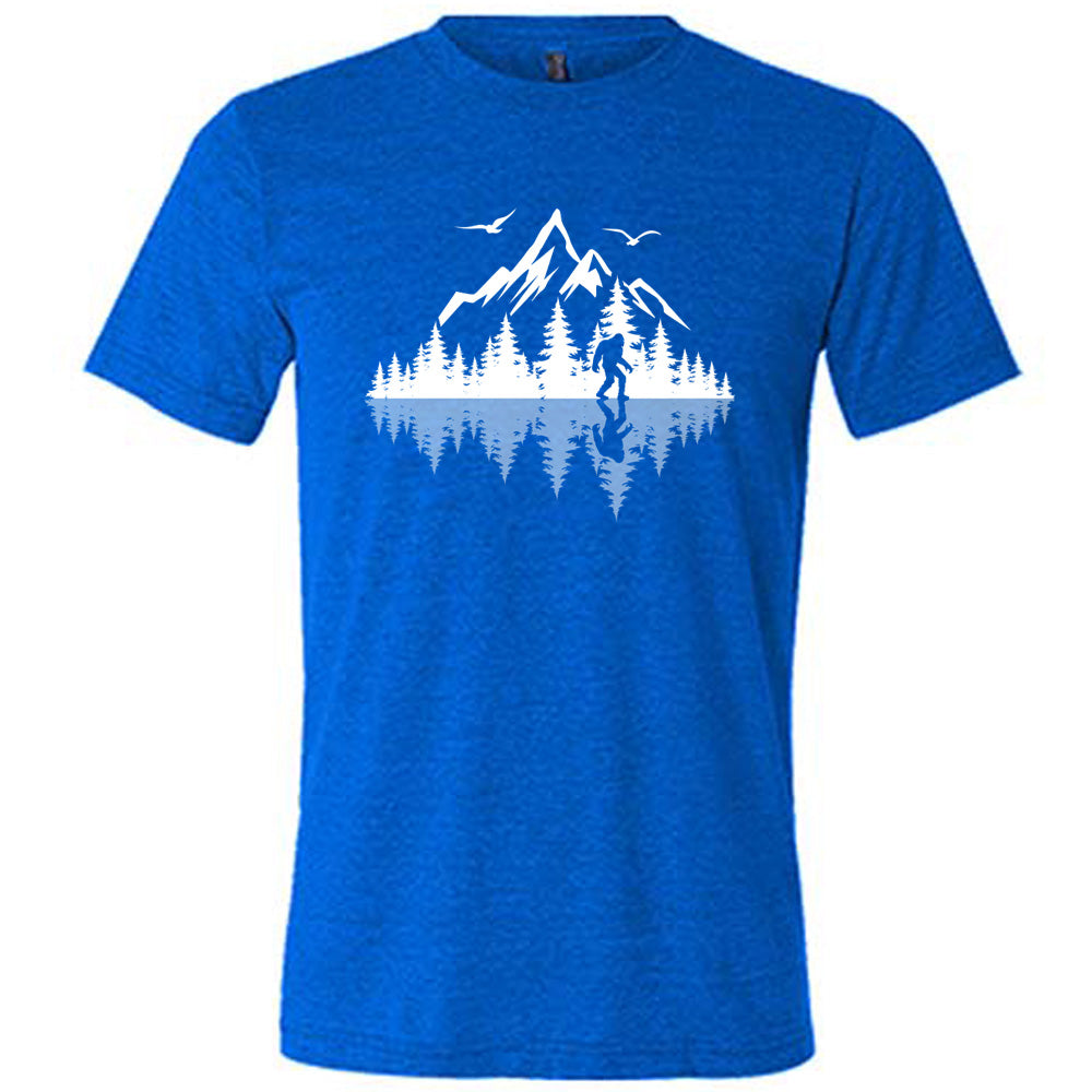 Blue colored shirt with bigfoot in nature with reflection graphic on it
