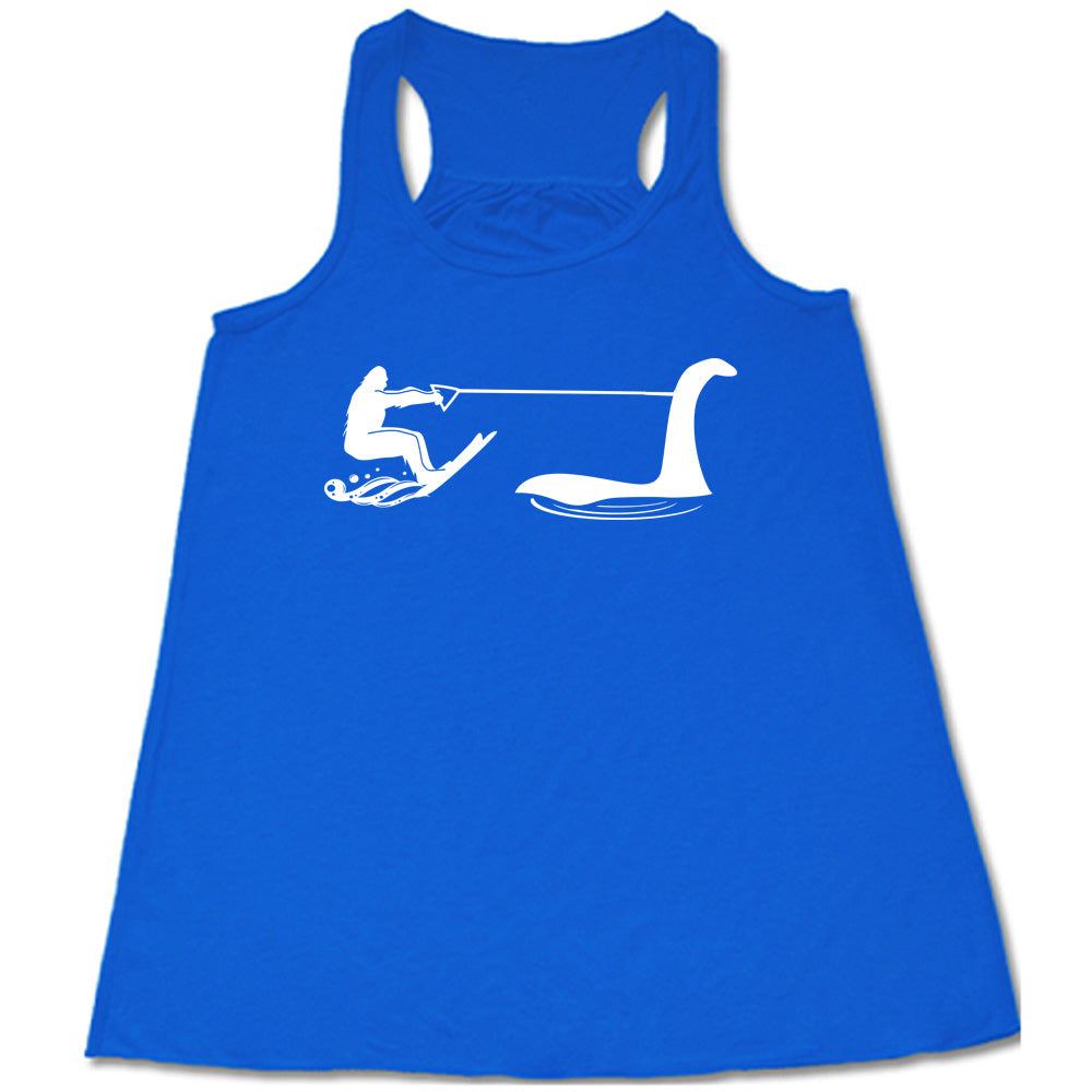 Blue colored flowy tank with bigfoot wakeboarding with Nessie graphic on it