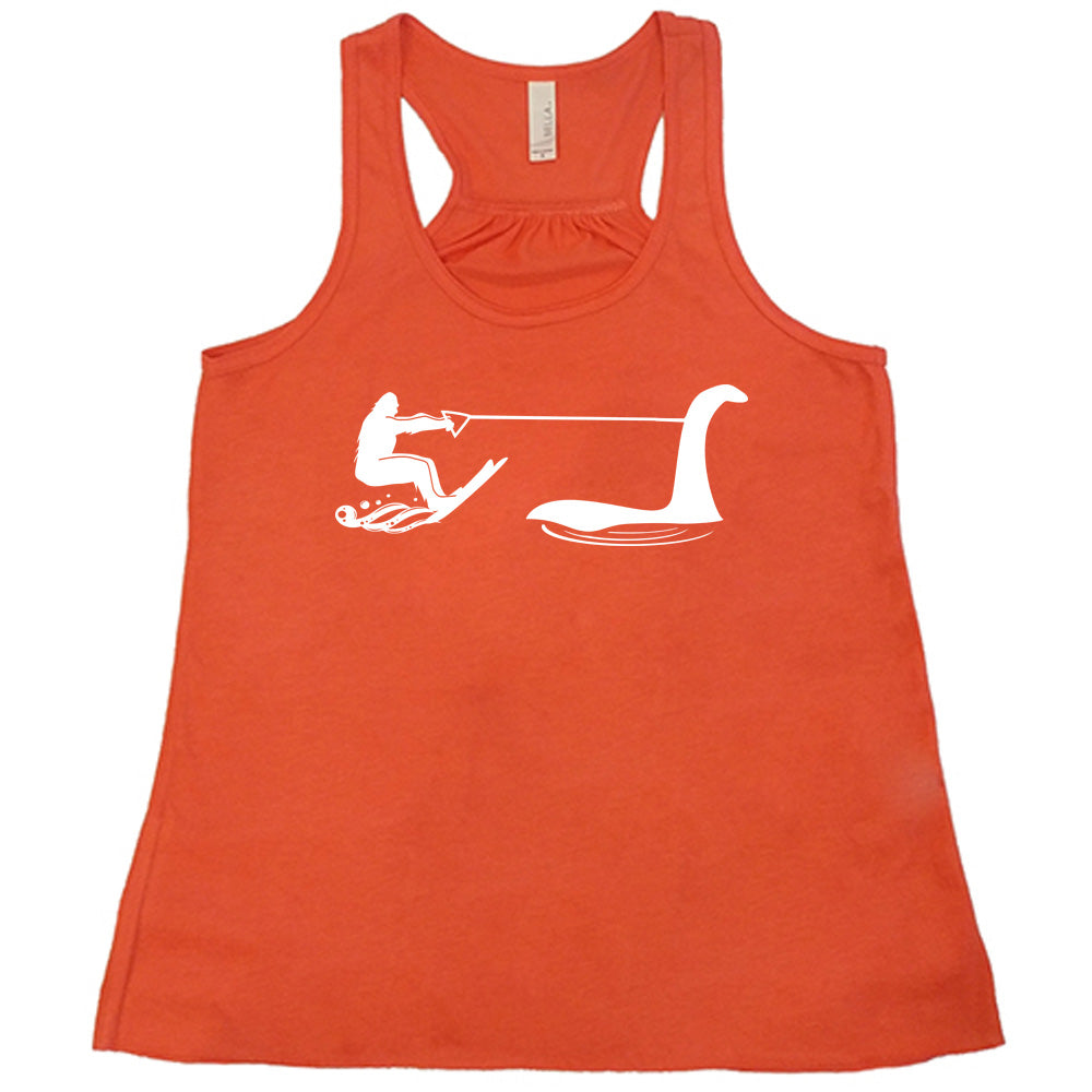 Coral colored flowy tank with bigfoot wakeboarding with Nessie graphic on it