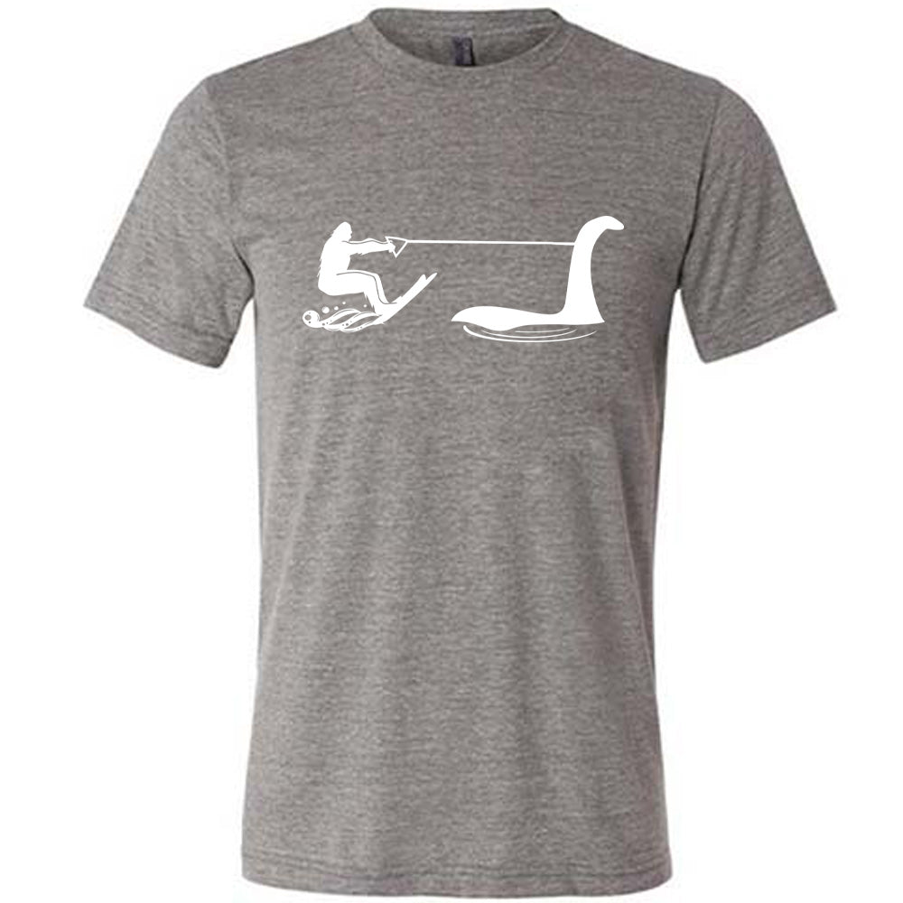 Grey colored shirt with bigfoot wakeboarding with Nessie graphic on it
