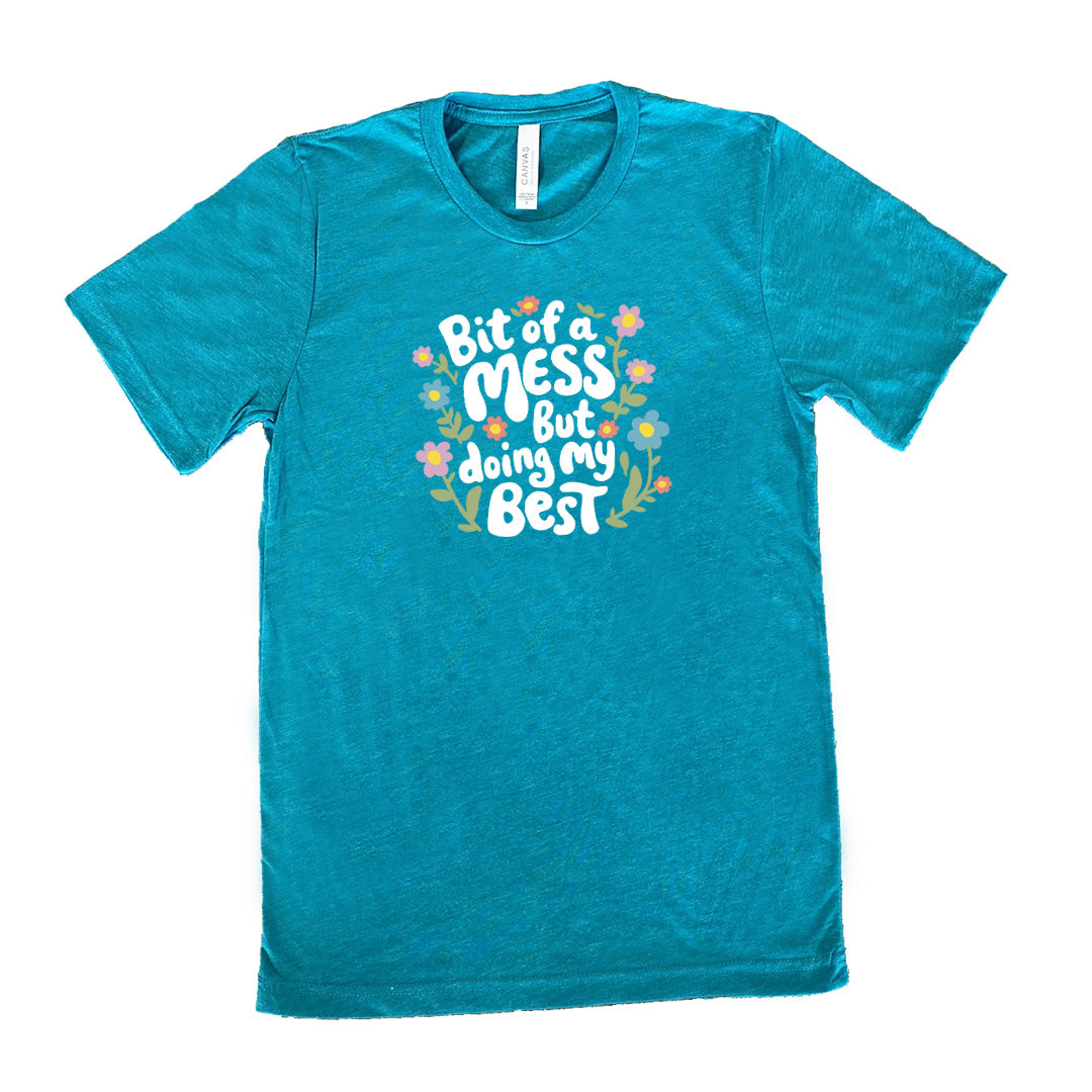 teal shirt with the text "Bit of a Mess, But Doing My Best" on it