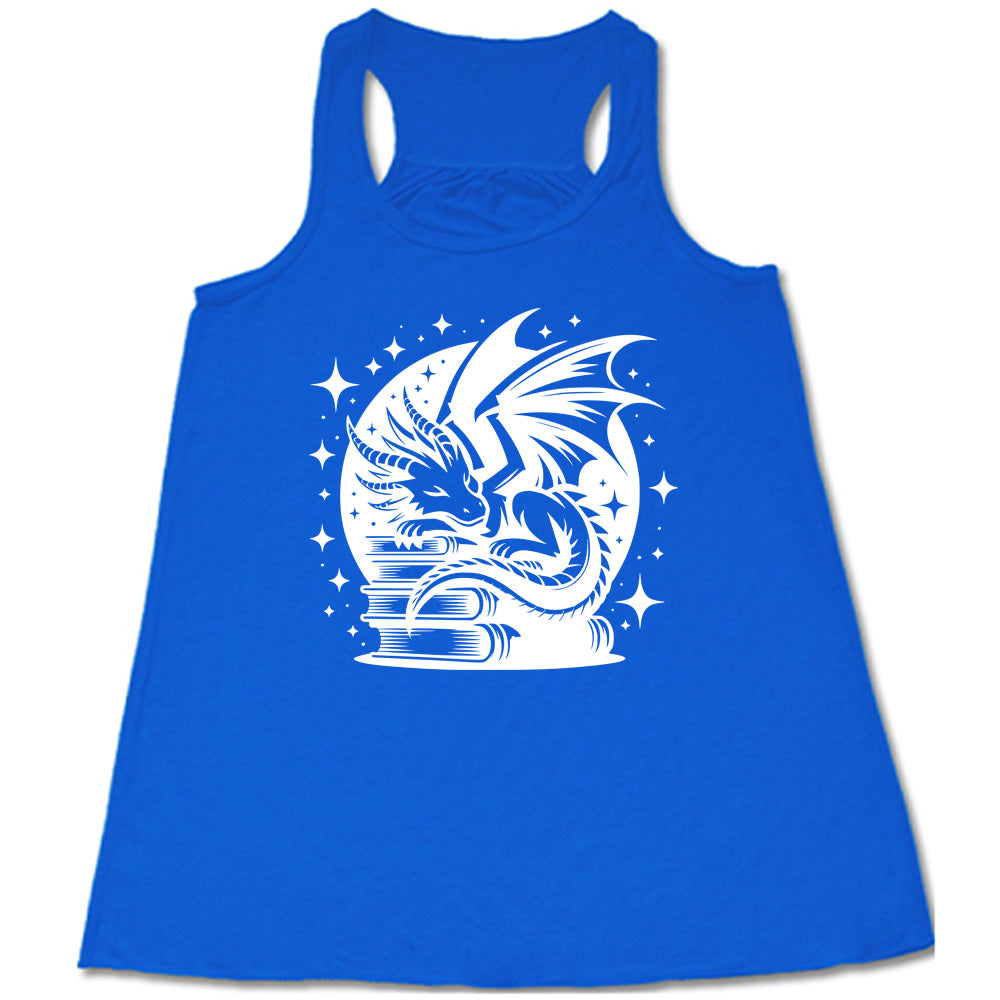 blue racerback tank with the graphic of a dragon resting on a stack of books, in front of a full moon, with many stars around