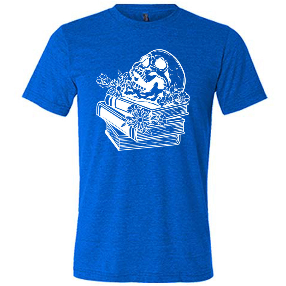 blue unisex tee with the graphic of an open-mouthed skull atop a stack of books, with flowers