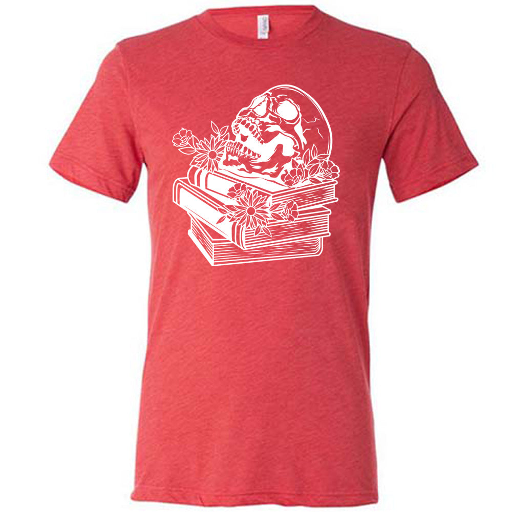 red unisex tee with the graphic of an open-mouthed skull atop a stack of books, with flowers