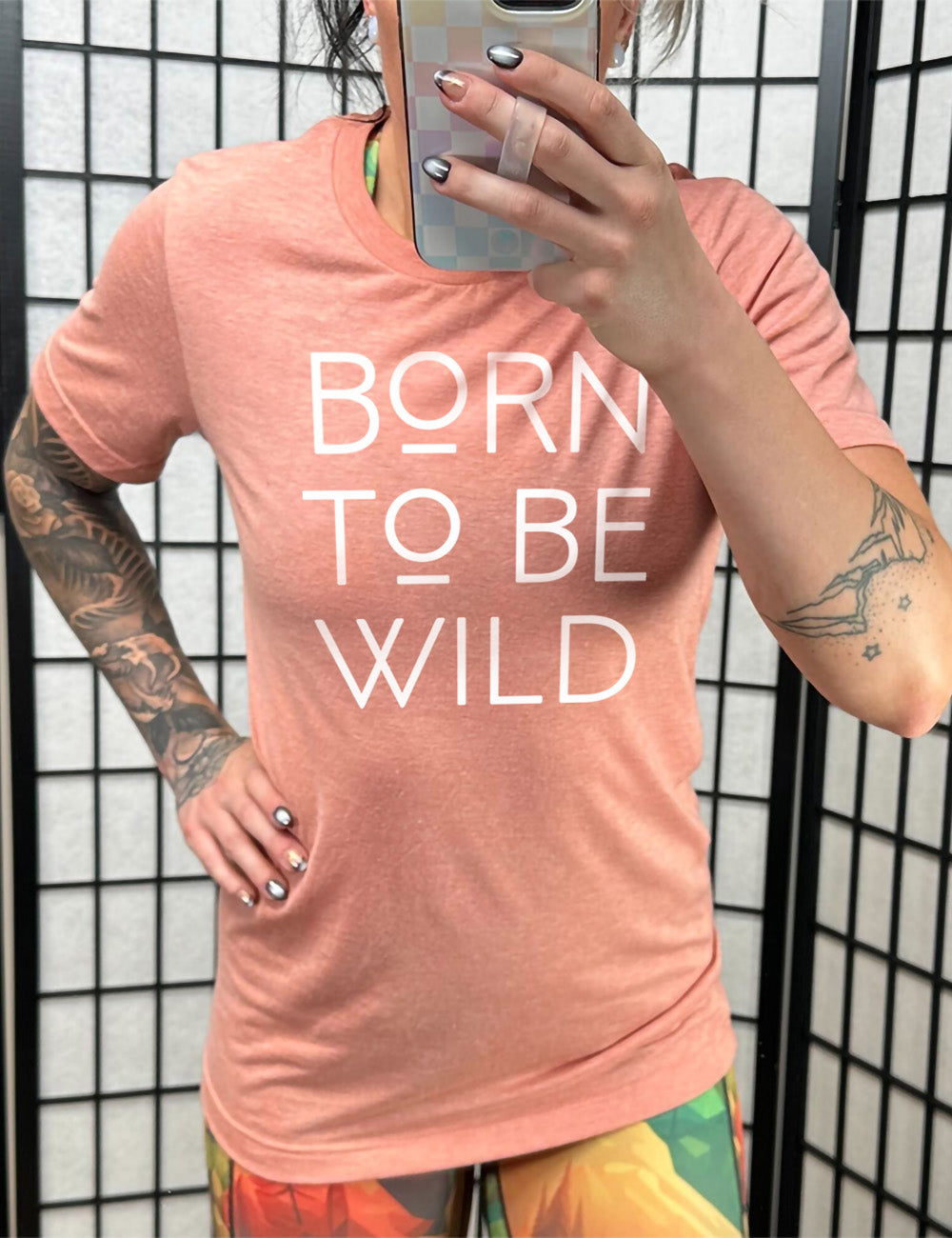 sunset unisex tee with the words "born to be wild" on it, with both of the letters "o" underlined
