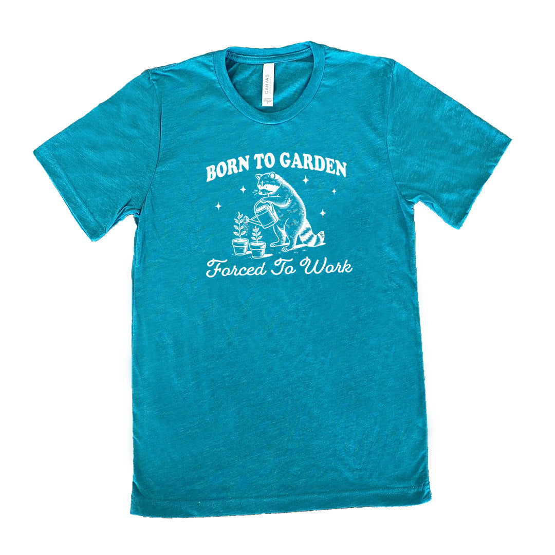 Teal colored shirt with a gardening raccoon graphic on it that says "Born to Garden, Forced to Work"