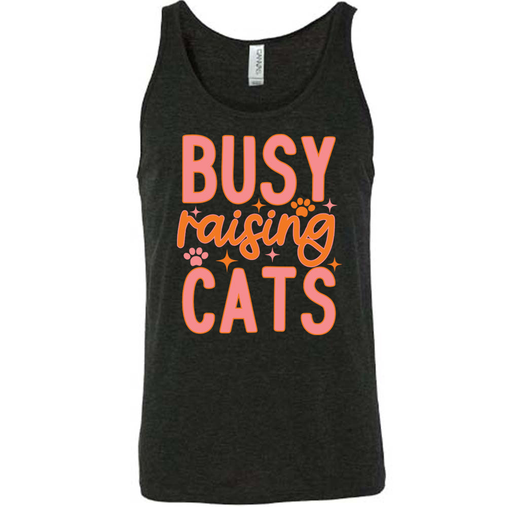 black unisex tank with the words "busy raising cats" on it, with graphics of a couple small paw prints and a number of little stars