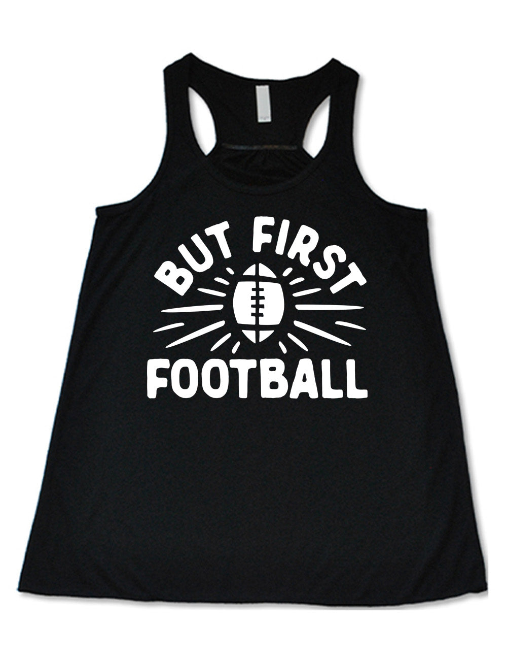 black flowy racerback tank with the words "but first football" in capital font, with "But first" arching over the graphic of a football, with rays beaming off of it