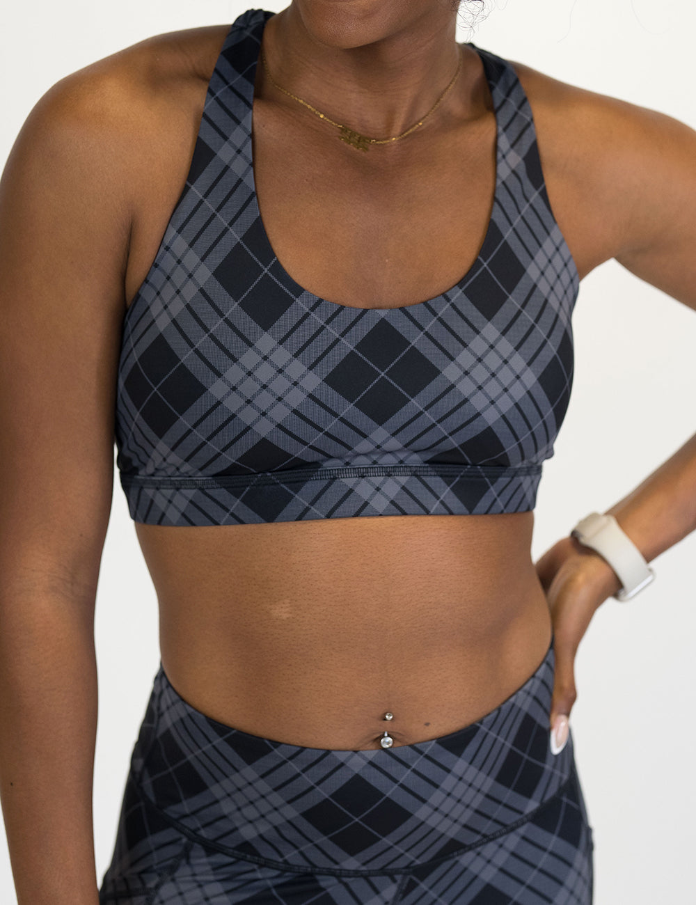 model wearing a black and grey plaid sports bra
