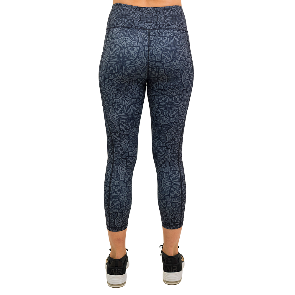 back of the black mandala pattern capri leggings against a white background