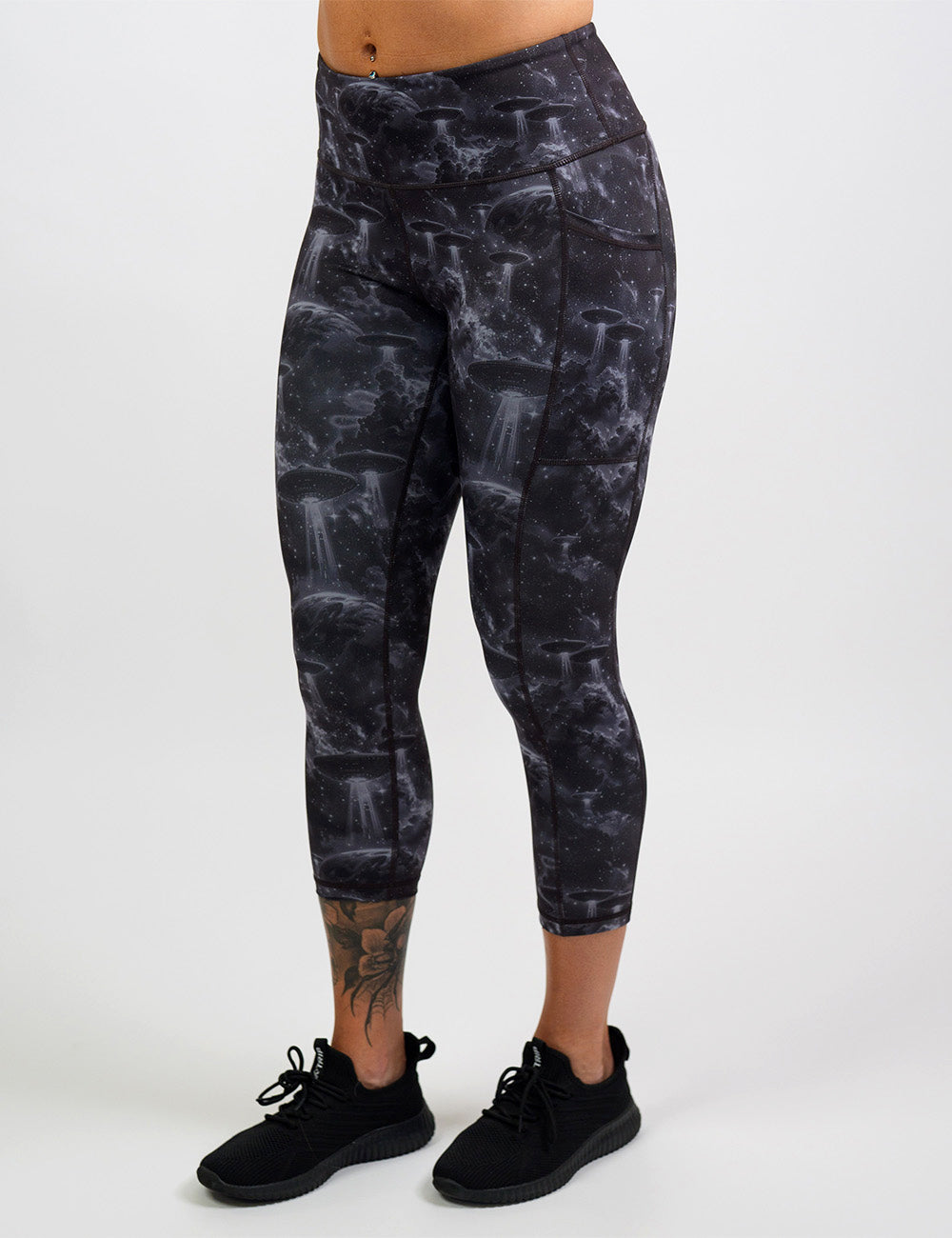 front of the alien space ship invasion capri leggings against a white background
