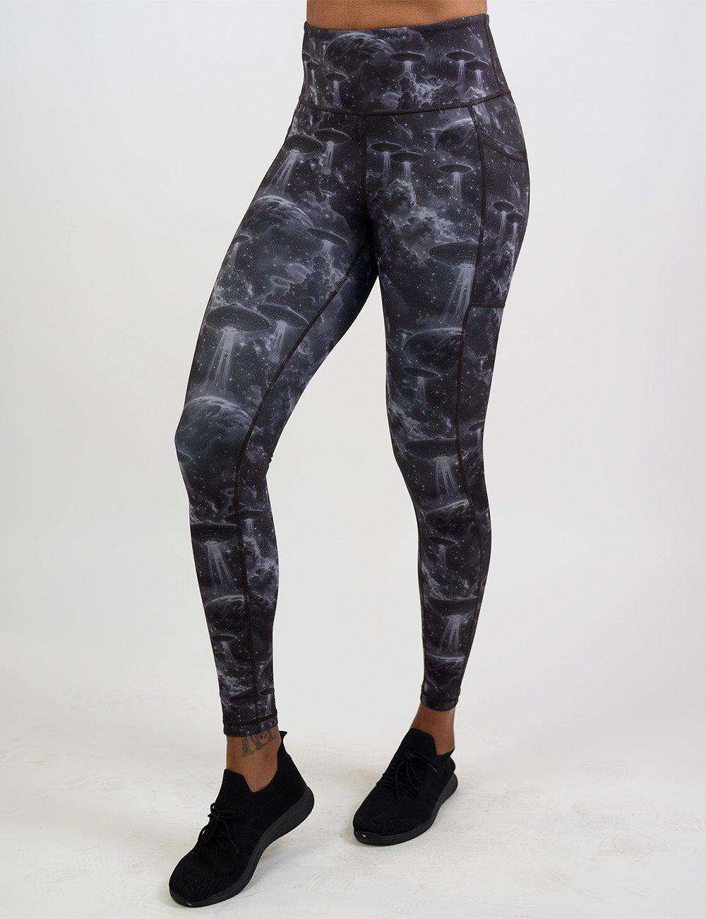 front of the alien space ship invasion full length leggings against a white background