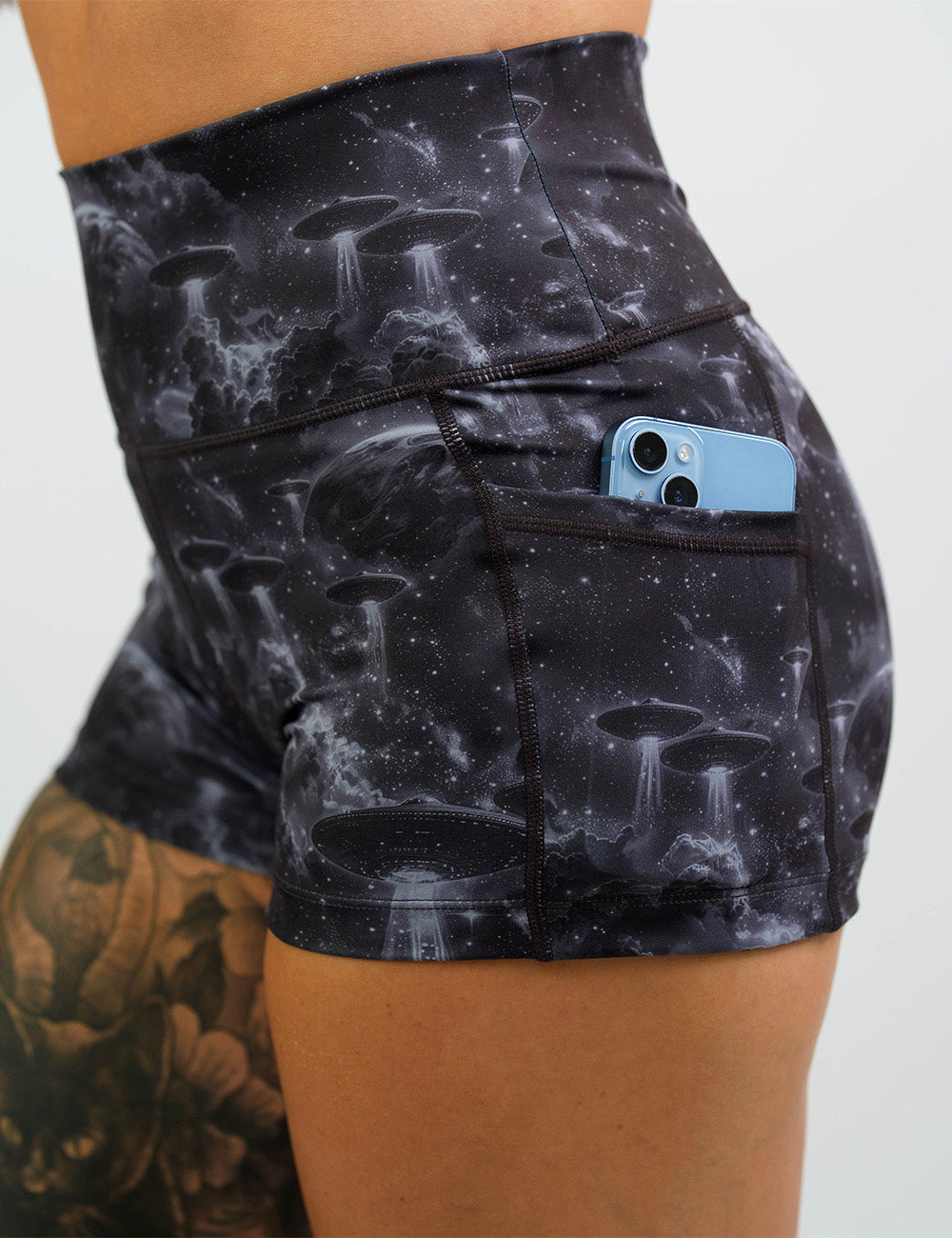close up of the alien space ship invasion shorts with a phone in its pocket