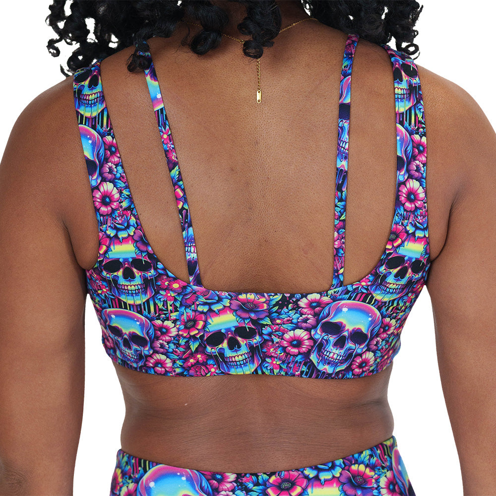 back of the neon skull print sports bra against a white background