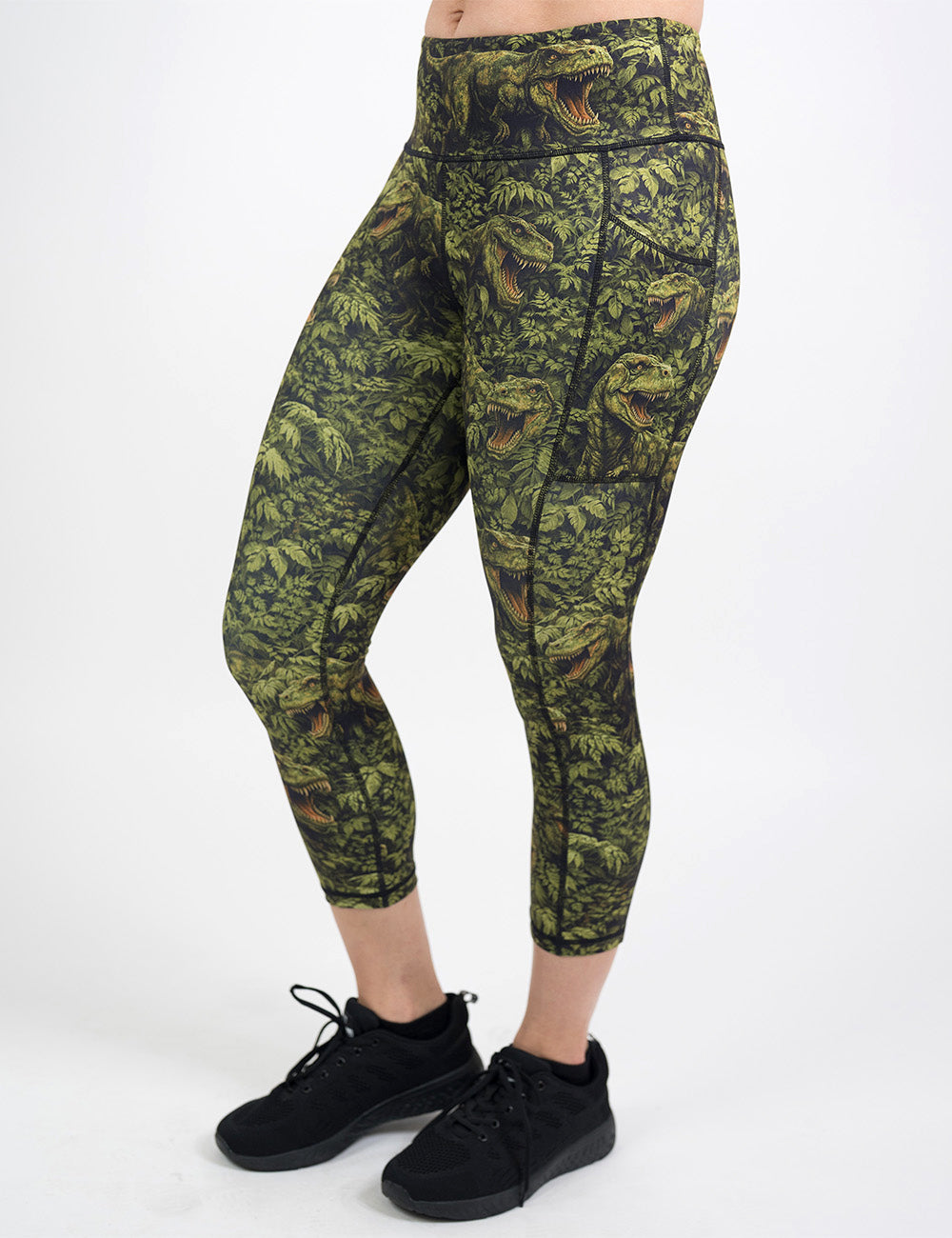 front of the capri t-rex in a forest leggings against a white background