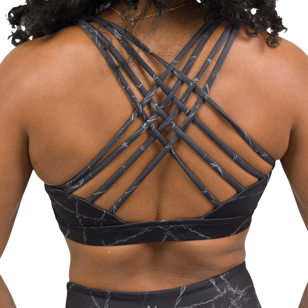 back of a black sports bra with a white barbed wire pattern on it
