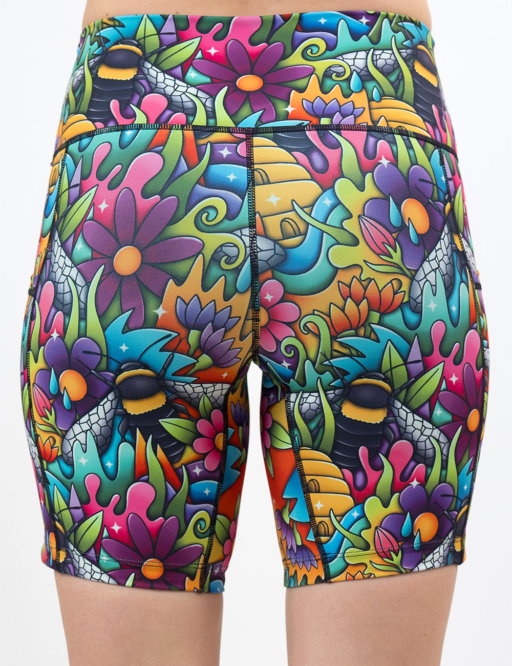back of the cartoon bees against colorful cartoon flowers 7 inch shorts against a white background