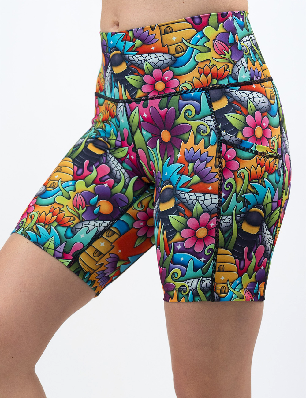 the cartoon bees against colorful cartoon flowers 7 inch shorts facing the front against a white background