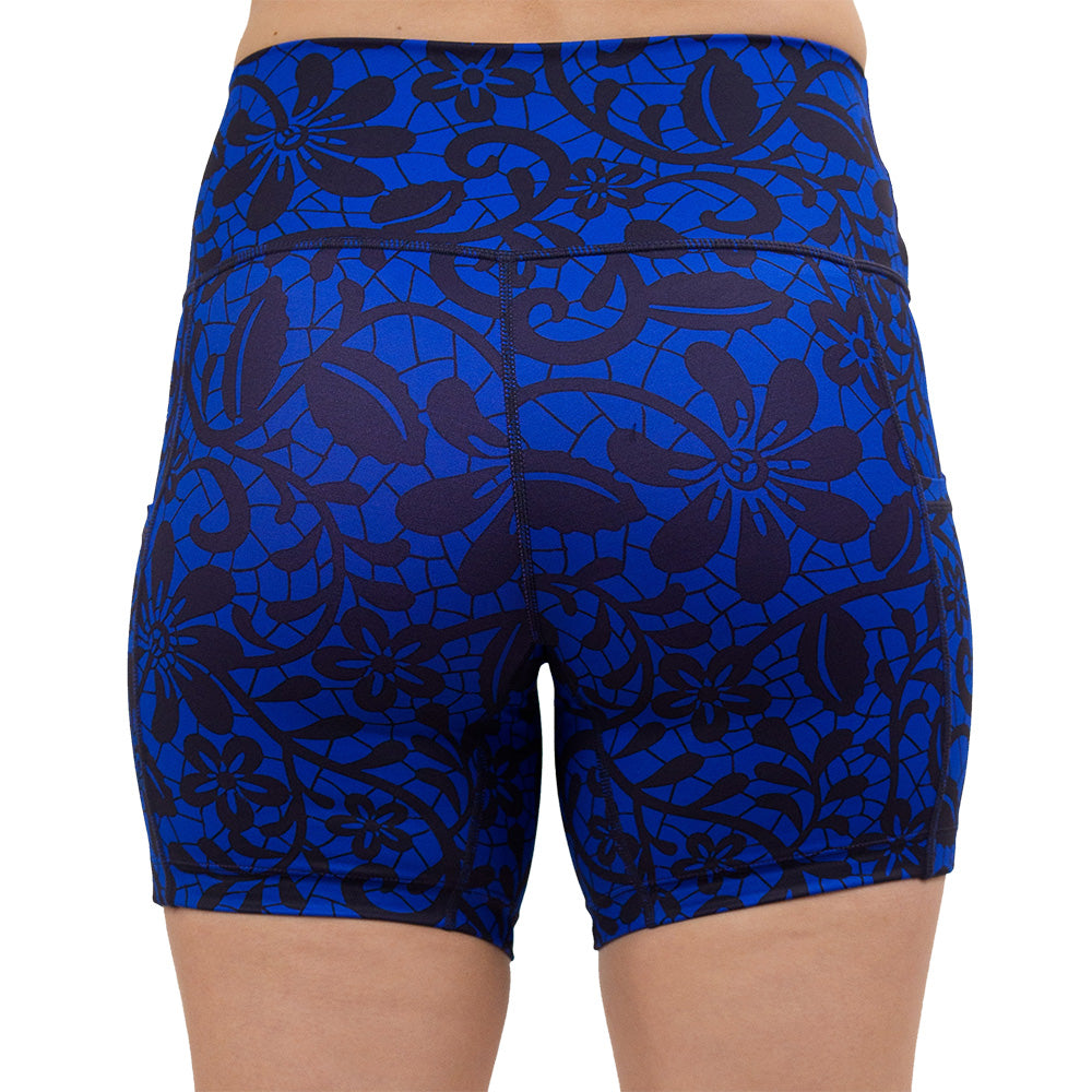 back of the 5 inch black floral against a dark blue background shorts against a white background